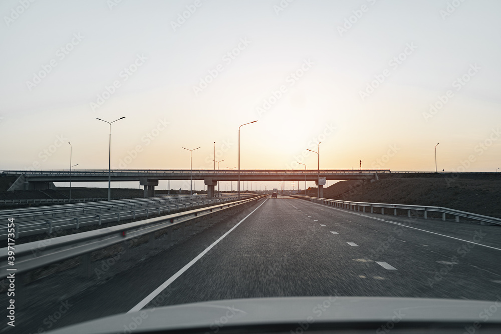 Empty highway at dawn, view from driver's perspective