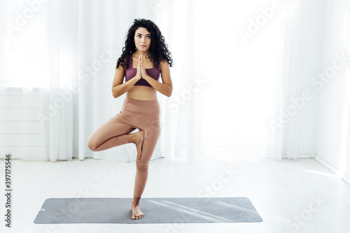 Beautiful female brunette yoga asana gymnastics flexibility body fitness