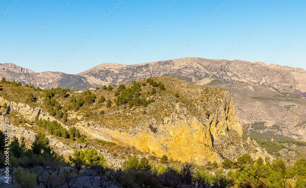 Scenic mountain view of landscape with blue sky. Hiking destination, Aitana mountain massif in Spain.