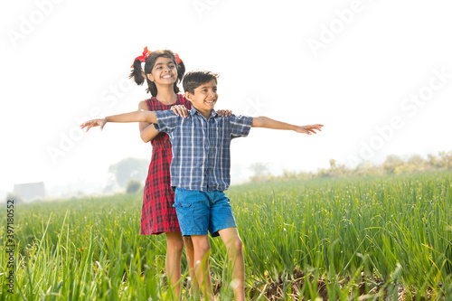 Happy children having fun in agricultural field photo