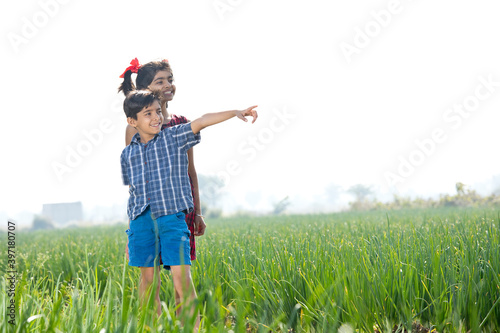 Happy children having fun in agricultural field