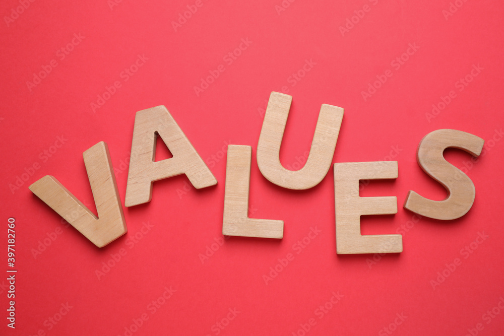 Word VALUES made of wooden letters on red background, flat lay