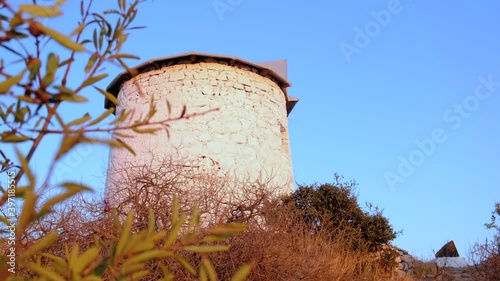 Old, white, stone windmill in Bodrum, Turkey at sunset. Traditional, touristic place.