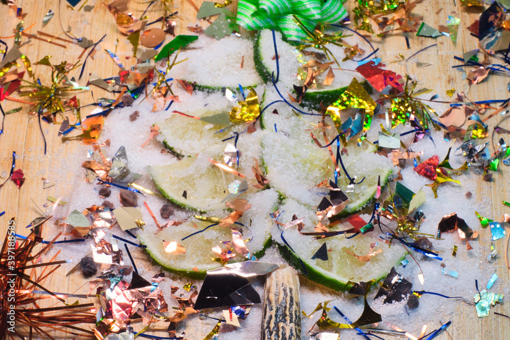 Fototapeta premium Sliced fresh lime decoratef with bright holiday decor as a symbol of festive Christmas tree