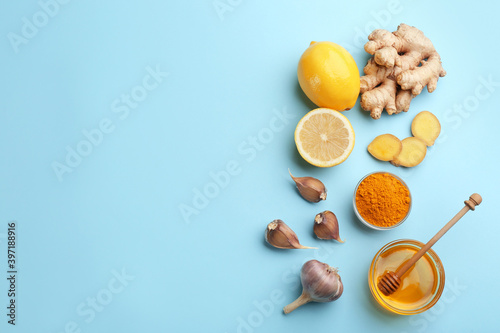 Flat lay composition with different natural antibiotics on light blue background, space for text