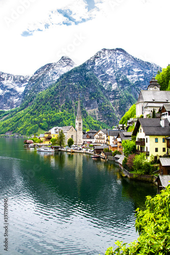 View of buildings and old church along the coastline. View of the mountains and monuments of the city. Hallstatt, Austria