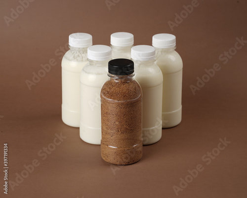 product photo of unlabeled bottled bottles containing kefir milk. one of the bottles contains palm sugar. The combination of the benefits of palm sugar and kefir milk.