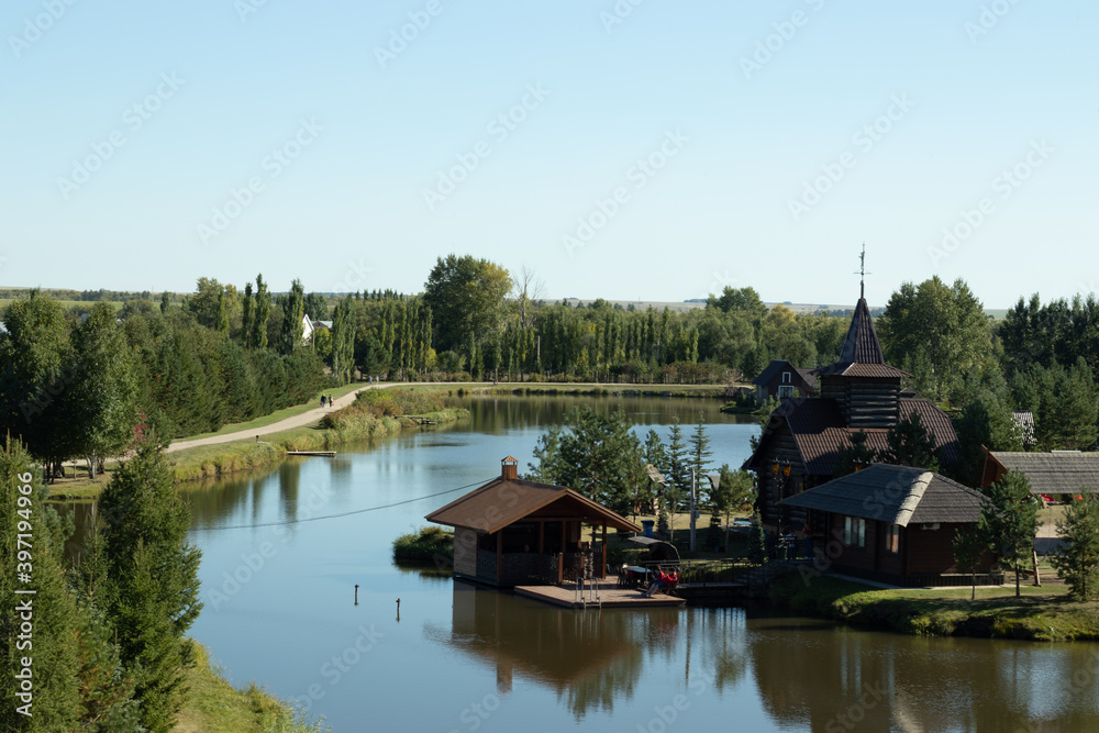 Fototapeta premium Lake house in a wooded area. Countryside life, farm near river. Landscape
