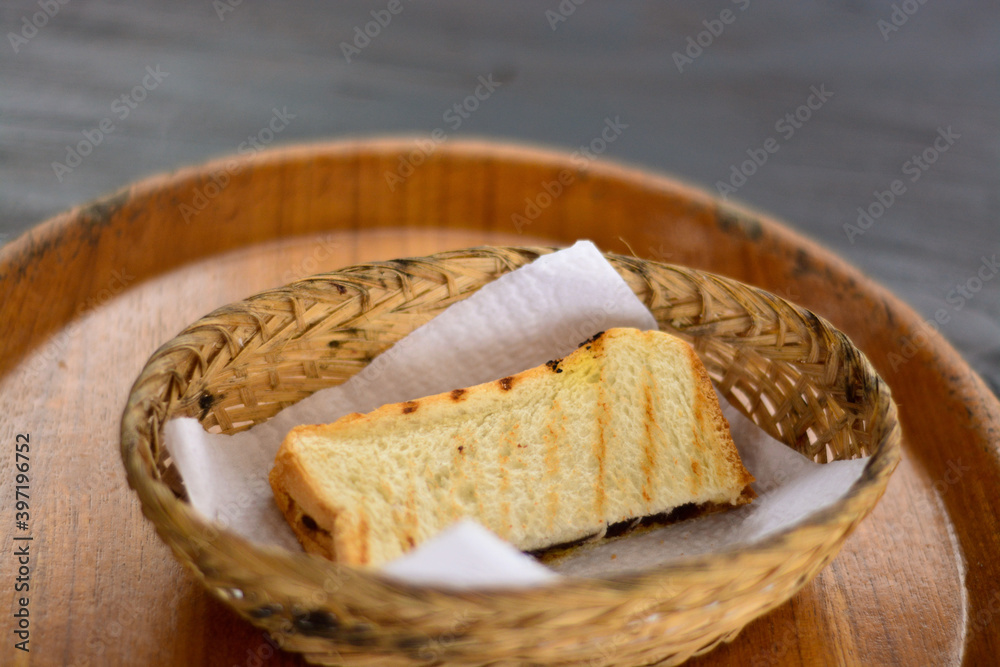 Delicious toast in a basket on the table. Delicious breakfast concept in the morning Delicious toast in a basket on the table. Delicious breakfast concept in the morning