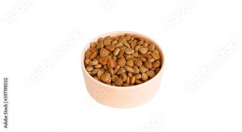 Pink bowl full of pet food isolated on a white background. Pieces of food of different shapes. copy space.