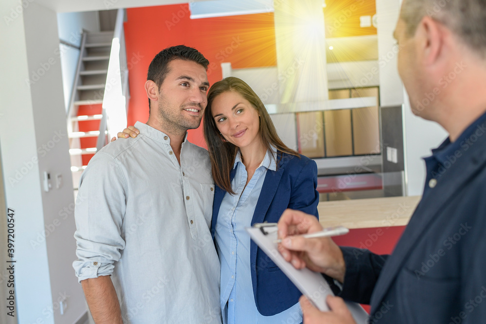 Female customer is trying to convince her boyfriend about the flat Female customer is trying to convince her boyfriend about the flat