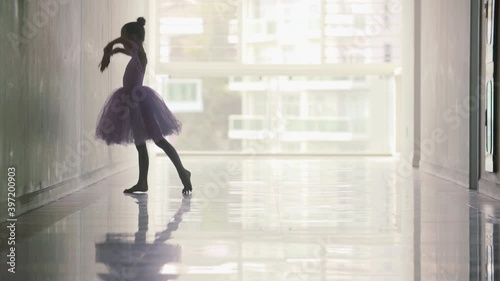 Silhouette of a beautiful slim graceful girl ballerina dancing