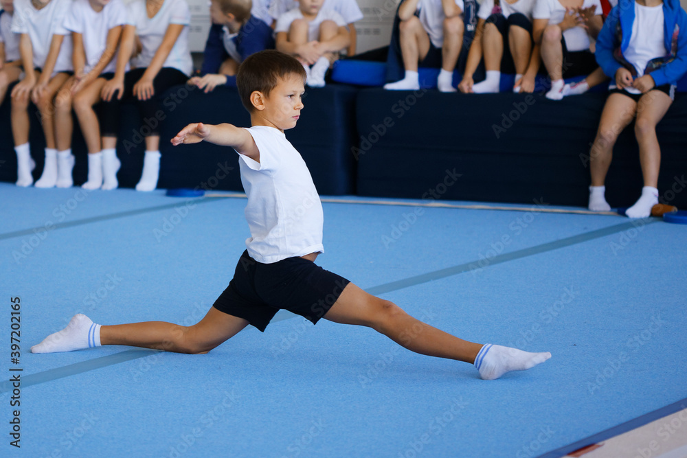 boy performing gymnastic exercises in the gym