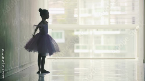 Charming little girl ballerina in a magnificent dress dancing ballet dance