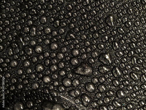 Water drops on black glass background