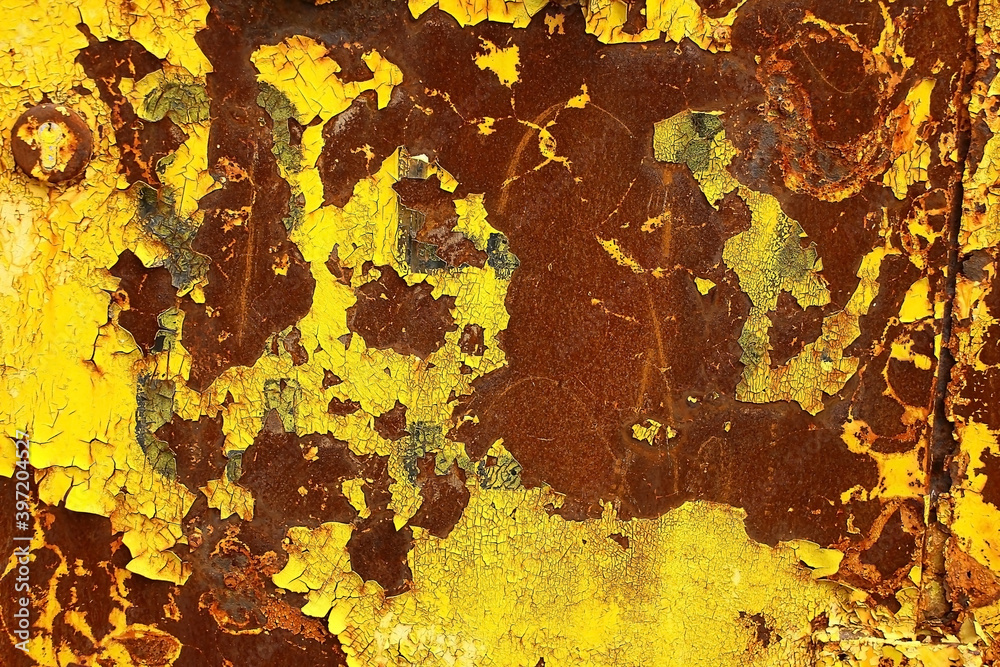 Shabby paint on an iron wall. Old yellow-brown metal. Vintage background.