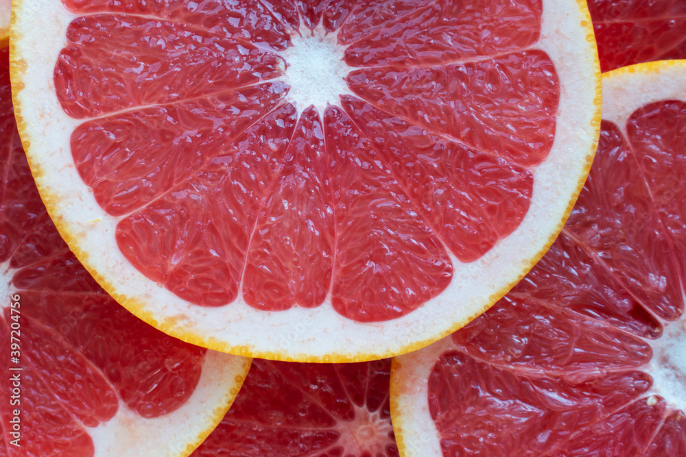 background texture of a slice of grapefruit, top view closeup