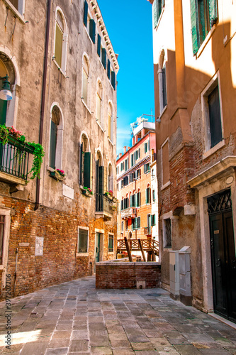 Fototapeta Naklejka Na Ścianę i Meble -  Sunny Venice, Italy. Old colorful buildings, narrow streets and bridges. Monuments of Venice