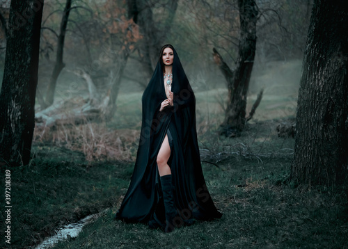 Фотография Mysterious fantasy gothic woman dark witch obsessed by evil