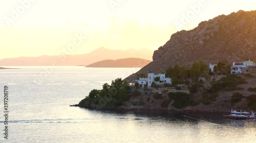 White Aegean houses of Yalikavak next to sea and sunset at Bodrum, Turkey. Bodrum is most popular summer vacation area for tourist in Turkey.  photo