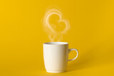 Steaming coffee cup on yellow background. White сoffee cup with steam. Smoke from hot coffee. Front view, copy space