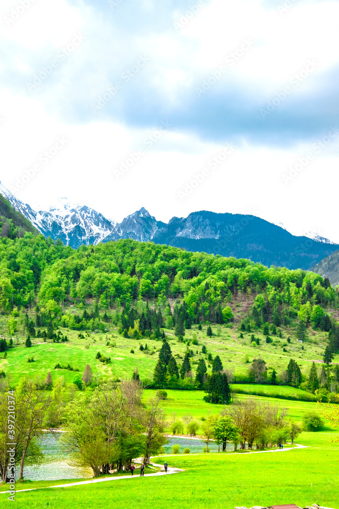 Summer in Slovenia. Mountain path. Green hills and cloudy skies. Triglav National Park, Julian Alps, Slovenia.