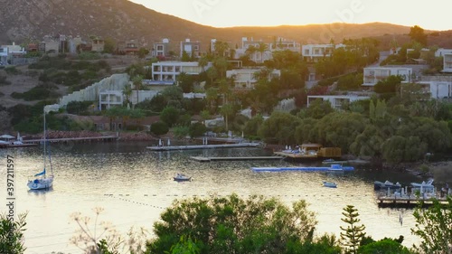 White Aegean houses of Yalikavak town next to sea, yacht and sunset at Bodrum, Turkey. Bodrum is most popular summer vacation area for tourist in Turkey. 