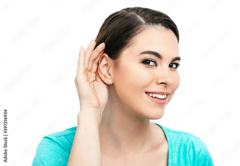 Hearing test concept. Positive hispanic woman holds hand near ear, isolated on white background