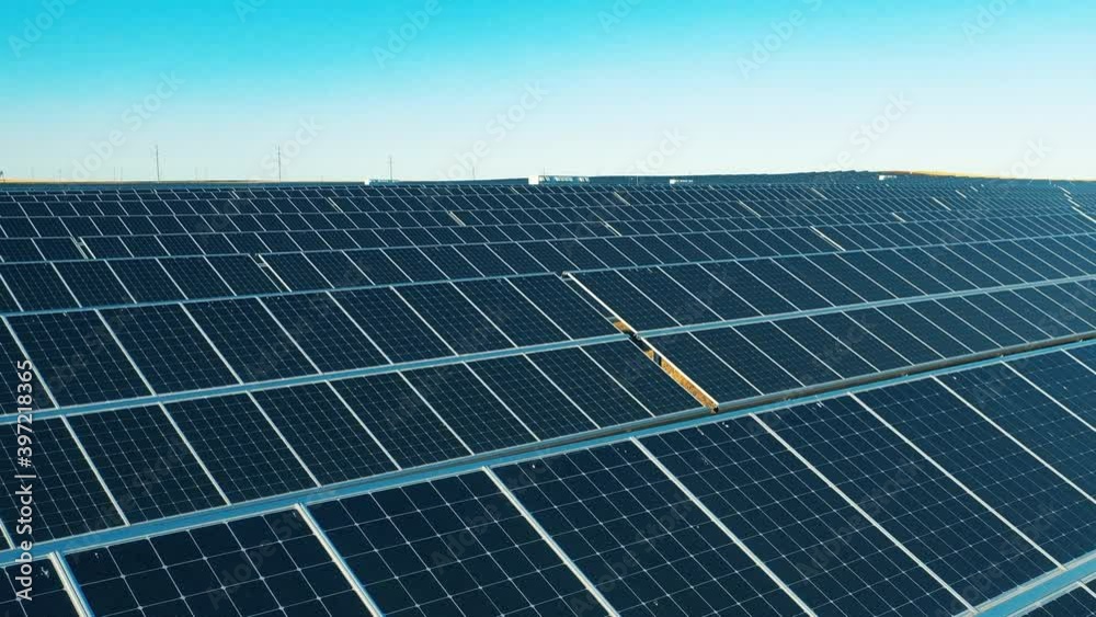 Aerial view of a solar power facility located in a field Aerial view of a solar power facility located in a field