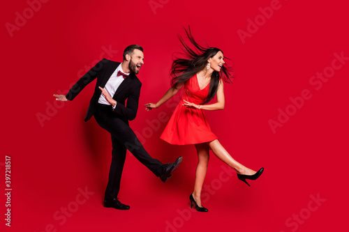 Full size profile photo of funny couple dance wear vivid dress black suit isolated on red color background