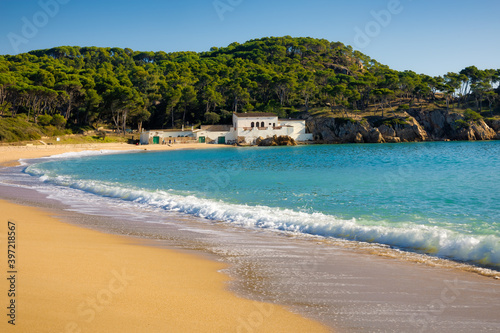 View of the northern area of ​​the protected urban beach of Castell de Palamos on a deserted sunny autumn day. Costa Brava, Catalonia, Spain