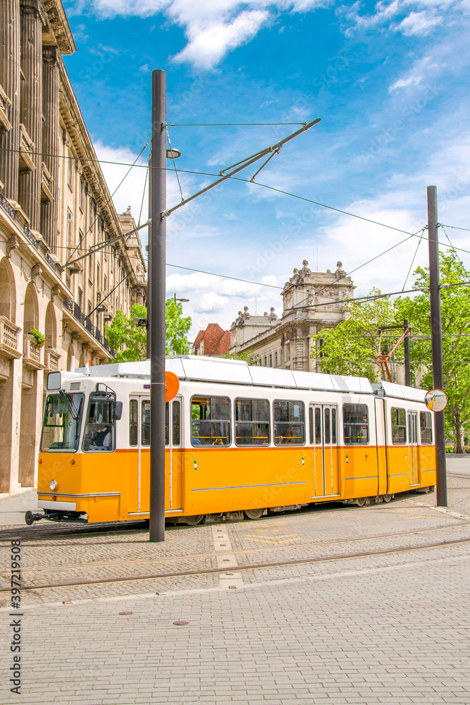 Fototapeta premium Yellow tram in Budapest - Public transport in Hungary. Old streets of capital city