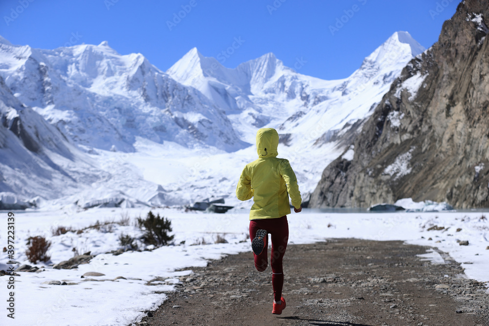 Woman trail runner  cross country running  in winter nature