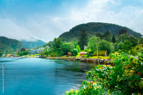 Beautiful Nature Norway  natural landscape. Village in the valley. Norwegian landscape. Beautiful fjords. Cloudy and rainy day. Lakes  mountains and classical Scandinavian houses