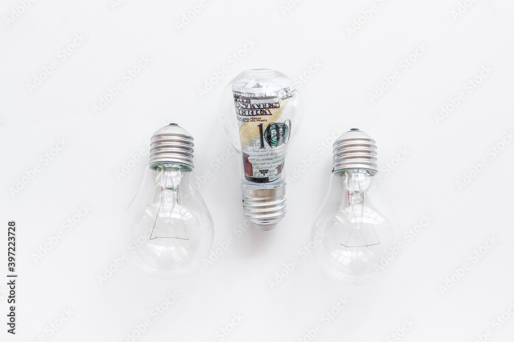 Green renewable energy eco concept with bulb and money inside Green renewable energy eco concept with bulb and money inside