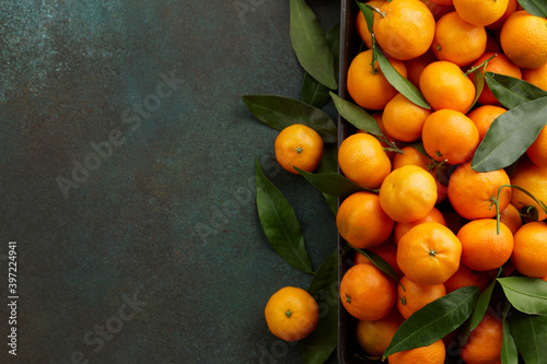 Fresh mandarin oranges with leaves, copy space. Seasonal winter fruits for Christmas. © kobeza