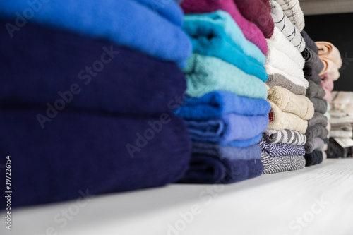 different color towels folded in the bathroom as background