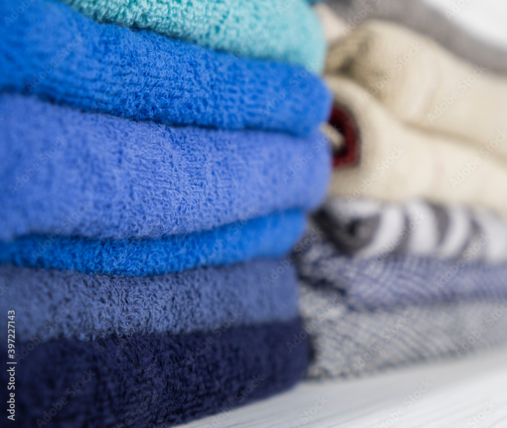 different color towels folded in the bathroom as background
different color towels folded in the bathroom as background