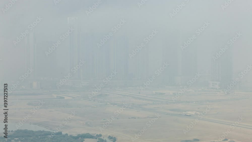 Skyscrapers on Al Reem Island in Abu Dhabi timelapse from above. Aerial citiscape from Al Reem Island at morning with heavy fog Skyscrapers on Al Reem Island in Abu Dhabi timelapse from above. Aerial citiscape from Al Reem Island at morning with heavy fog