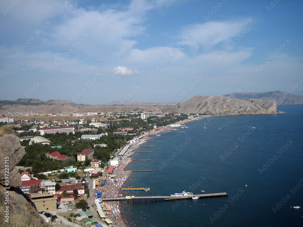 Panorama of the seaside city from a high point. View of the city and the Bay coast during the travel season.