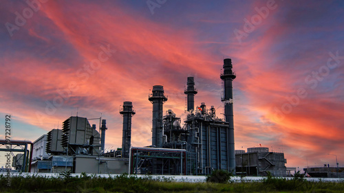 factory - petrochemical plant oil refinery plant in a petrochemical industrial estate at dusk  with huge storage tanks   chimneys throughout the factory