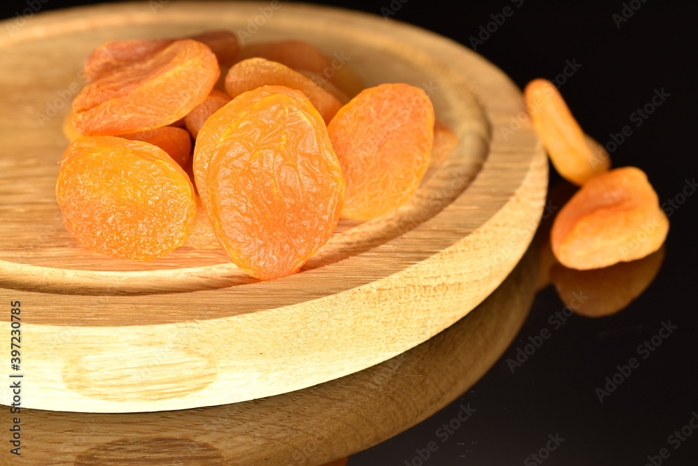 Bright golden organic dried apricots, close-up, isolated on black. Bright golden organic dried apricots, close-up, isolated on black.