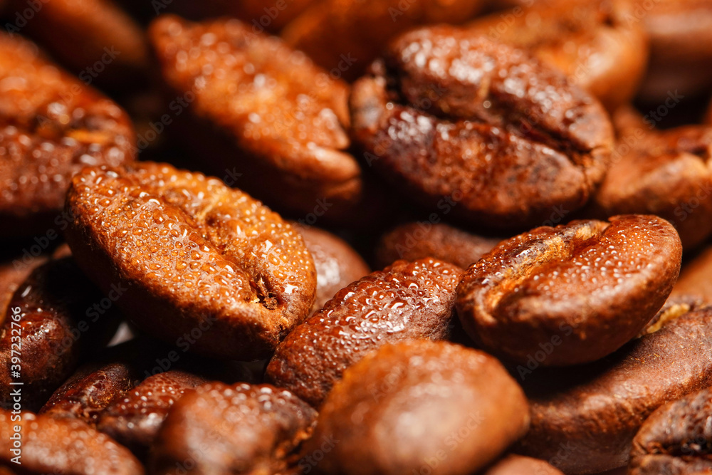 Macro view of fresh roasted Arabica coffee beans isolated on black background, extreme close up photo of fresh coffee beans on dark background. Macro view of fresh roasted Arabica coffee beans isolated on black background, extreme close up photo of fresh coffee beans on dark background.