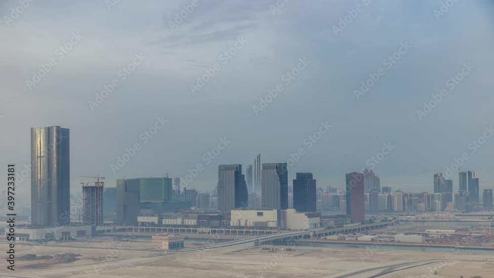 Skyscrapers on Al Reem and Al Maryah Island in Abu Dhabi timelapse from above. Aerial citiscape from Al Reem Island at morning with heavy fog Skyscrapers on Al Reem and Al Maryah Island in Abu Dhabi timelapse from above. Aerial citiscape from Al Reem Island at morning with heavy fog