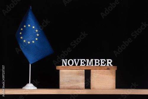 Wooden calendar of November with flag EU on black background. European Union Dates of November