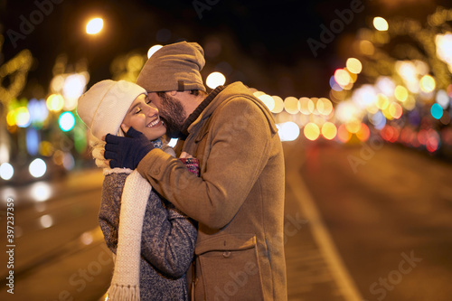 A young couple showing emotions in a walk of the city. Relationship, together, Xmas