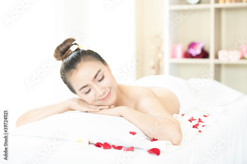 A woman lying in the private room of a spa salon.