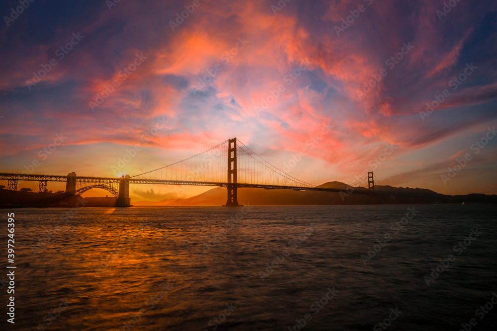 Gorgeous orange sunset with pink clouds over the Golden Gate in San Francisco, California. United States Gorgeous orange sunset with pink clouds over the Golden Gate in San Francisco, California. United States