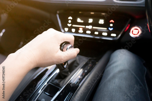 Male hand holds automatic gear stick inside modern sports car, concept travel driving © Sutthiphong