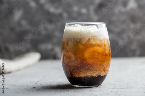 Ice cream with coffee cocktail in glass on grey background
